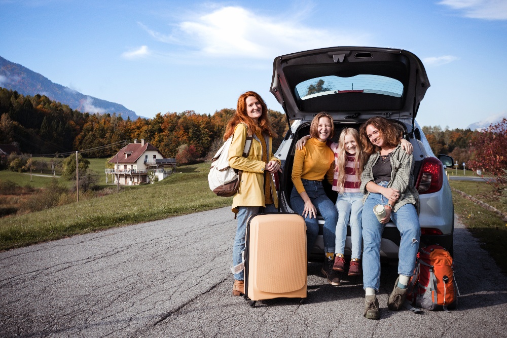 big-family-trip-happy-girls-travel-by-car-mamma-with-daughters-sitting-boot-1