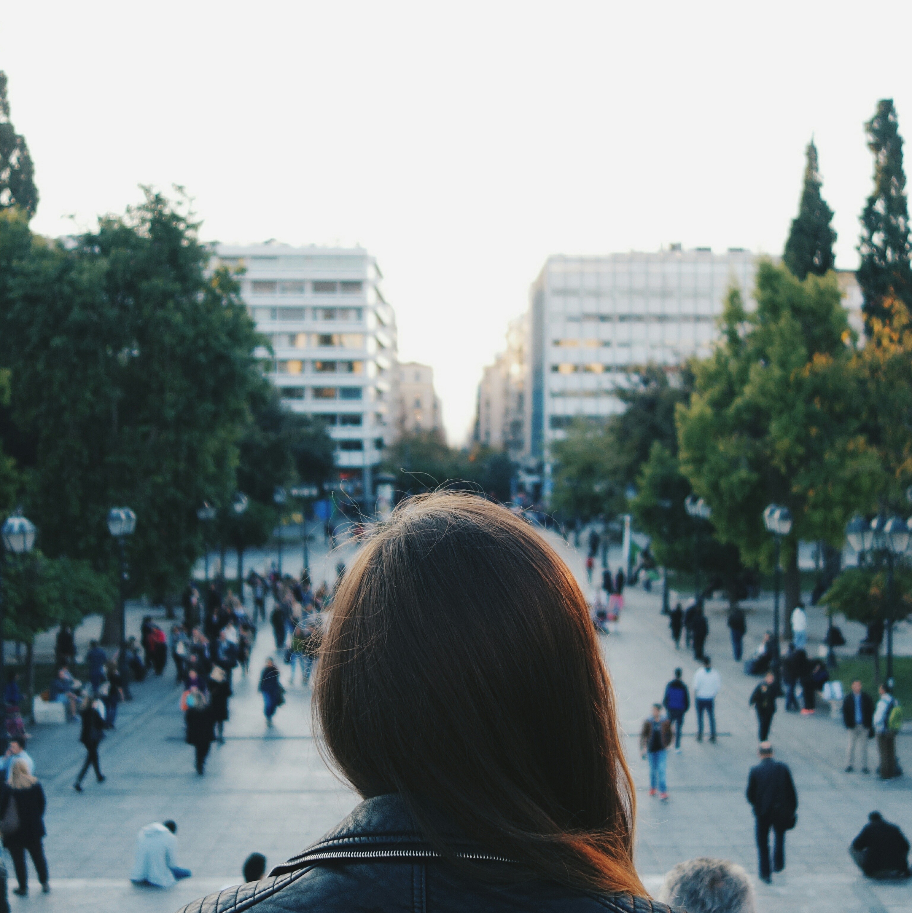 rear-view-woman-with-crowd-street-background